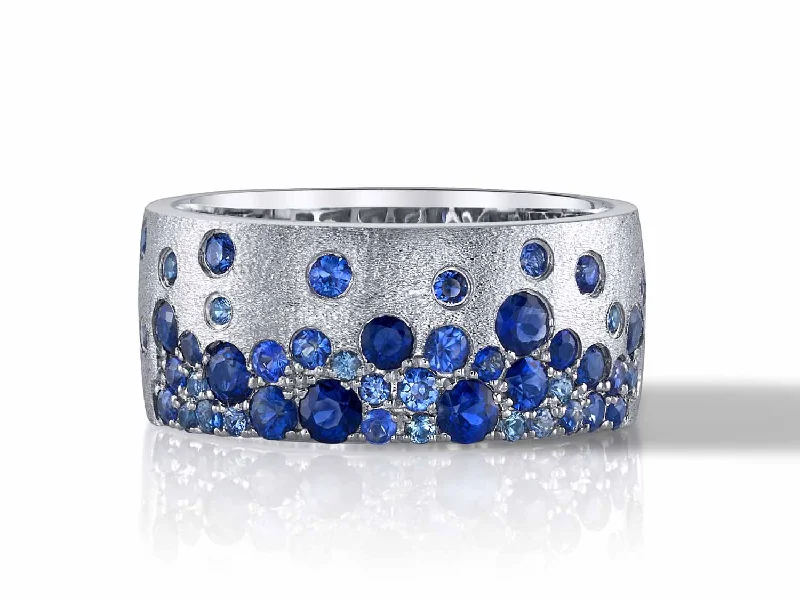 Rings with moonstone gems for ethereal glow -Scattered Sapphire Cluster Cigar Band Ring